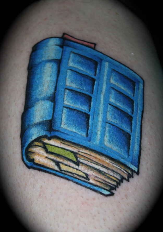 Blue cool book tattoo on arm