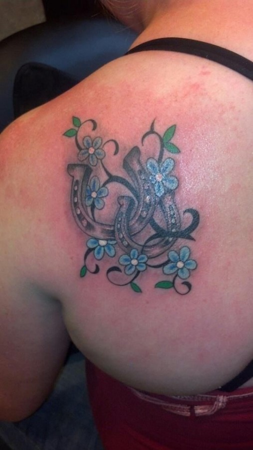 Blue flowers and horse shoe tattoo