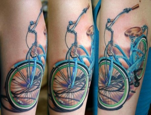 Blue lovely bicycle tattoo on arm