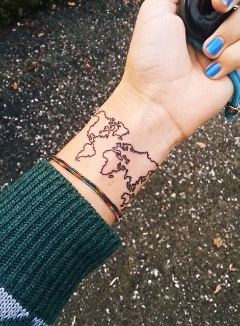 Blue nails and map tattoo on arm