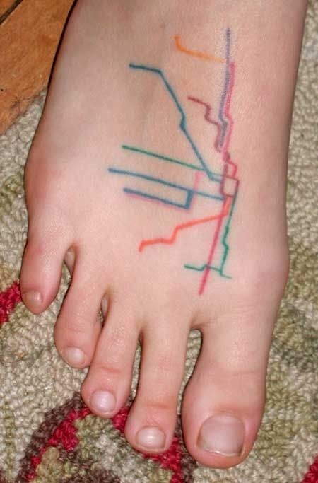 Blue, red, yellow and green map tattoo on legs