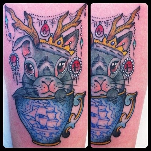 Blue ship, cup and rabbit tattoo on arm