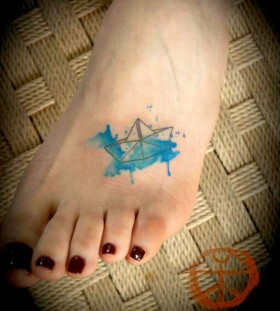 Blue ship origami tattoo on leg
