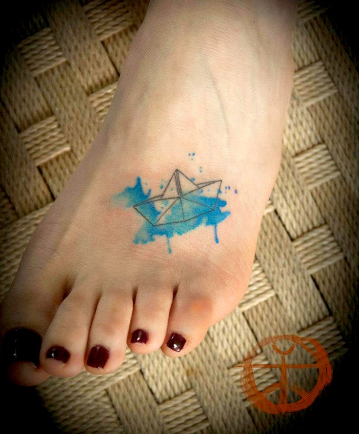 Blue ship origami tattoo on leg