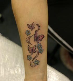 Blue small butterfly tattoo on arm