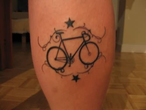 Blue stars and black bicycle tattoo on leg