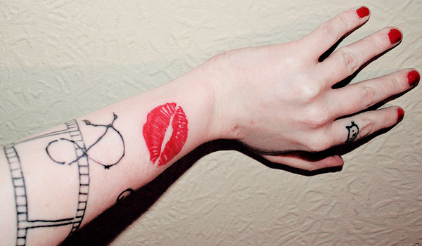 Breathtaking adorable lips tattoo on arm