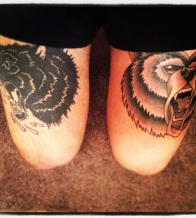 Brown bear and black wolf tattoo on leg