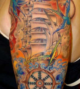 Colorful cute ship tattoo on arm