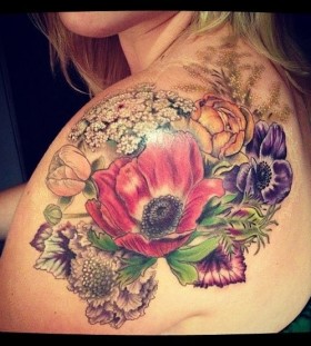 Colorful flowers and poppy tattoo on arm
