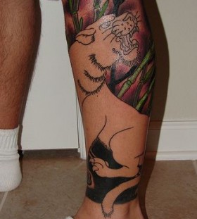 Colorful nature and tiger tattoo on leg
