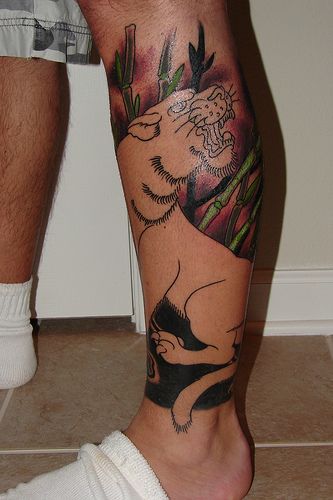 Colorful nature and tiger tattoo on leg