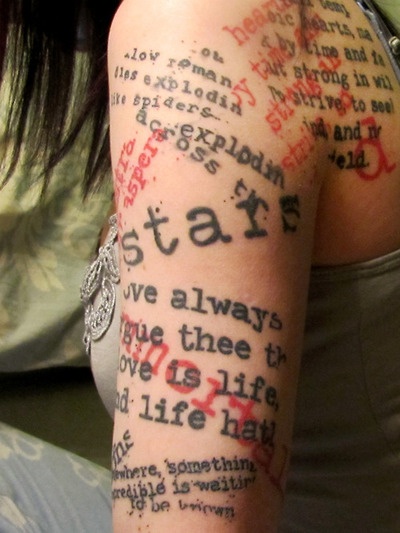 Colorful red and black quote tattoo on leg