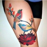 Colorful red bird tattoo on leg