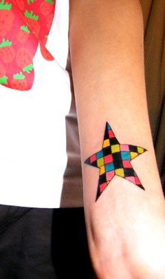 Colorful square star tattoo on arm