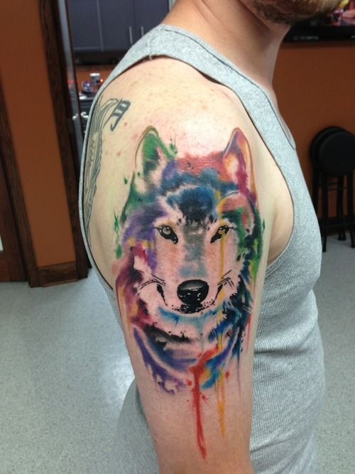 Colorful watercolor wolf tattoo on arm