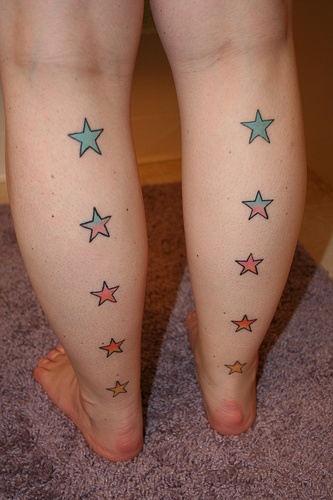 Colorful women star tattoo on leg