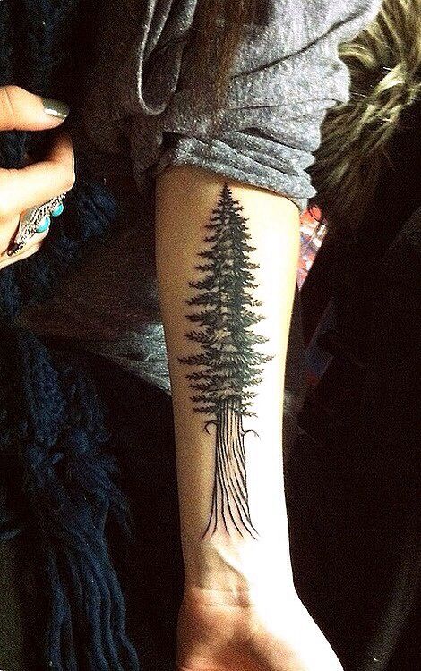 Cool girl’s tree tattoo on arm