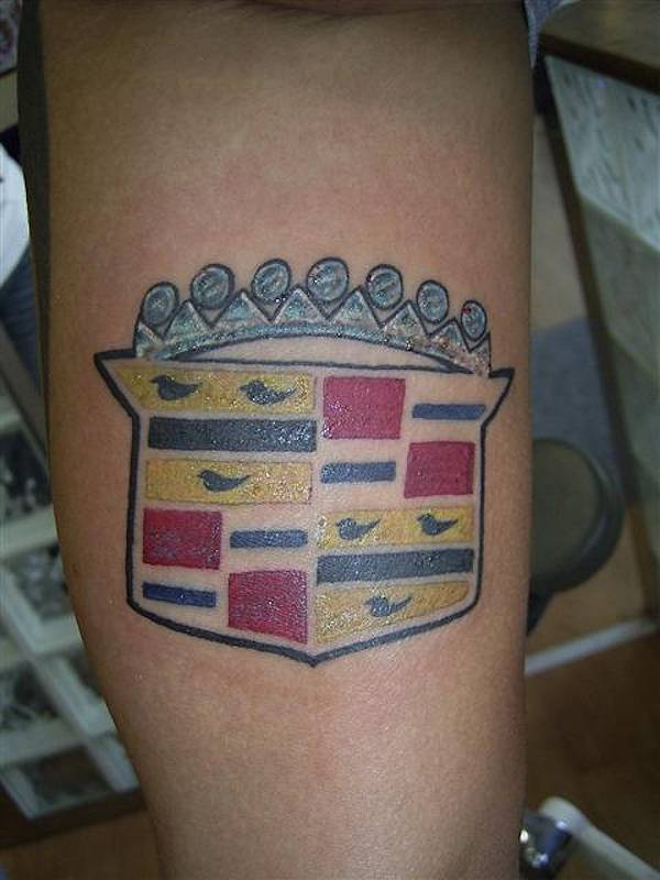 Crown and bird car tattoo on leg