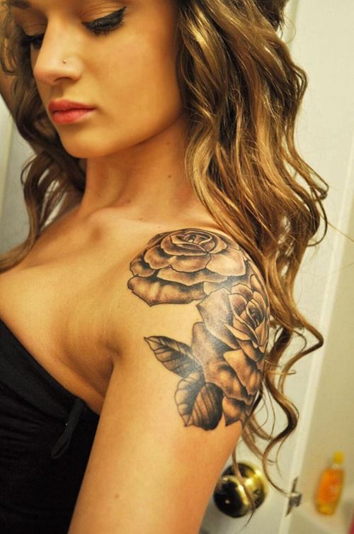 Curly hair girl rose tattoo on shoulder