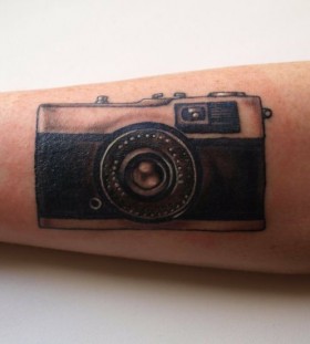 Cute black camera tattoo on arm