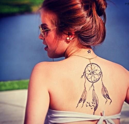 Cute girl with dream catcher tattoo