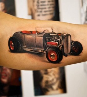 Cute red and black car tattoo on arm