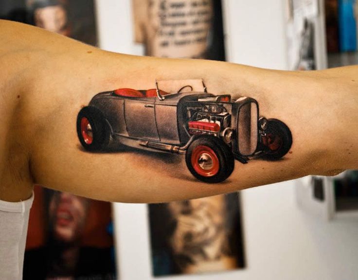 Cute red and black car tattoo on arm