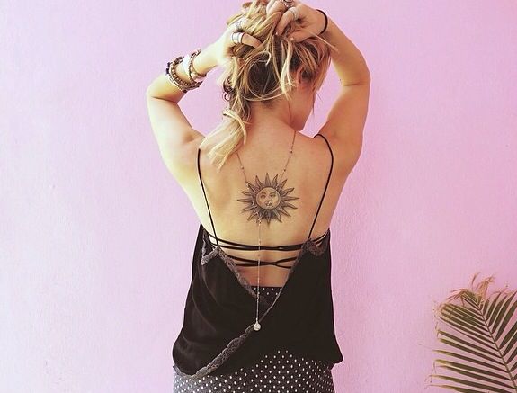 Cute simple back sun tattoo