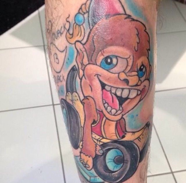 Funny monkey and car tattoo on leg