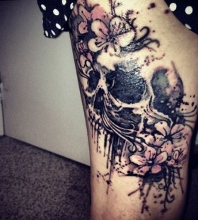 Girl skull and flower tattoo on leg