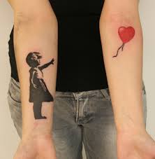 Girl with balloon tattoo on arm