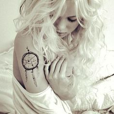 Girl with dream catcher tattoo on arm