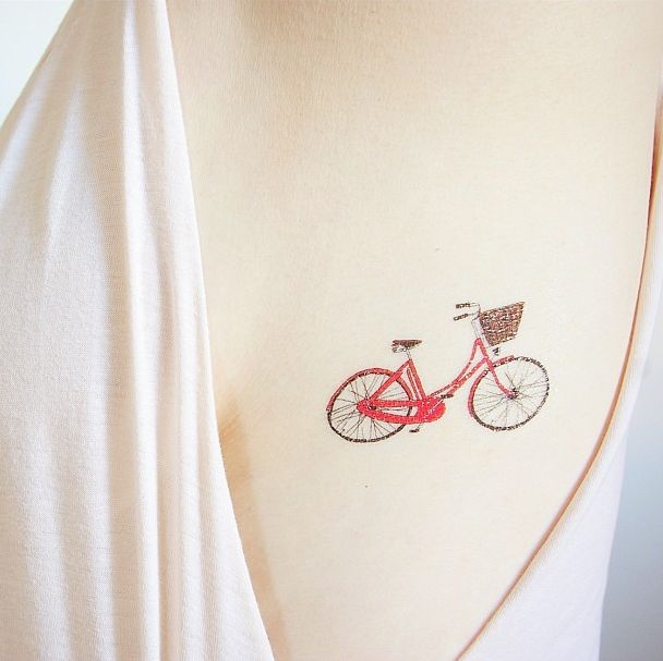 Girl with vintage bicycle tattoo