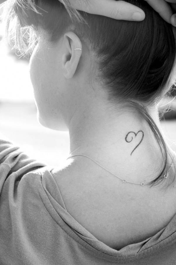 Girl’s neck heart tattoo