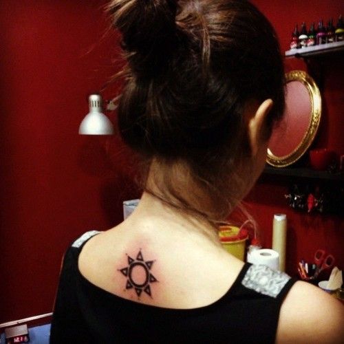 Girl’s ornaments back sun tattoo