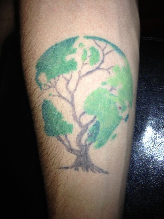 Globe in a tree tattoo