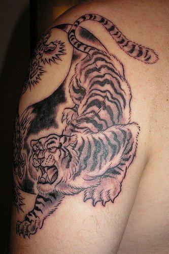 Gorgeous angry tiger tattoo on arm