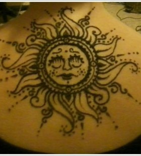 Gorgeous black back sun tattoo