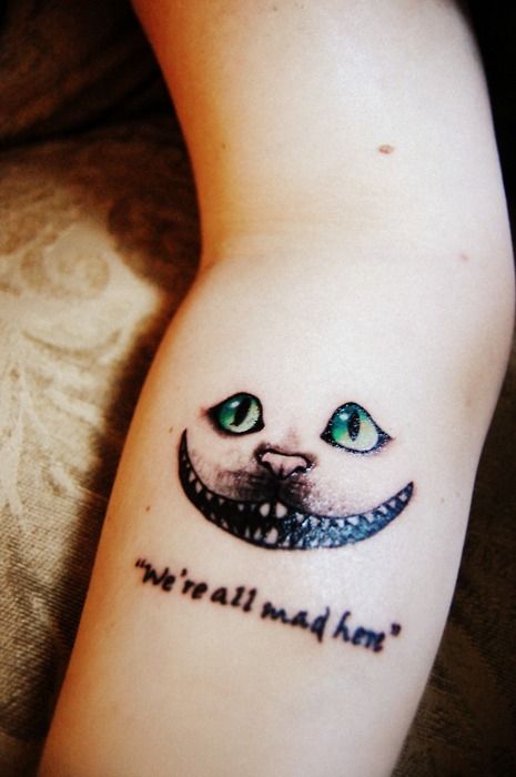 Gorgeous green eye of cat quote tattoo on arm