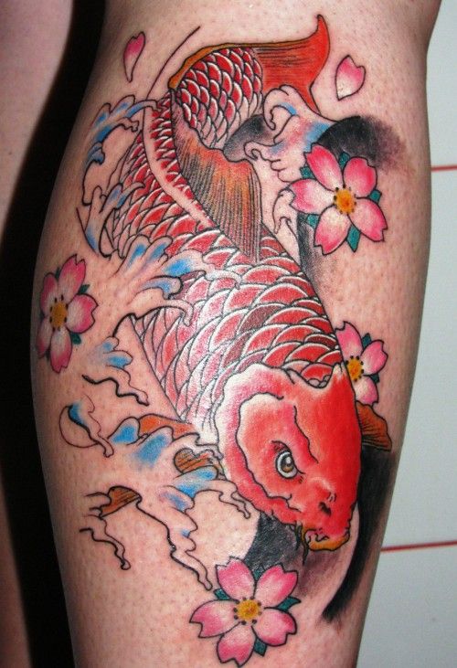 Gorgeous red fish tattoo on leg