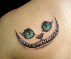 Green eye cat tattoo on arm