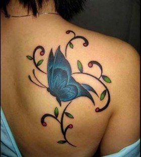 Green leaf and blue butterfly tattoo on shoulder