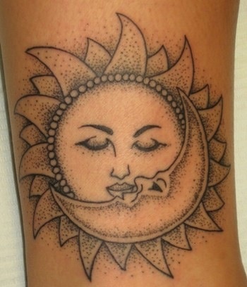 Inner arm moon and sun tattoo on arm