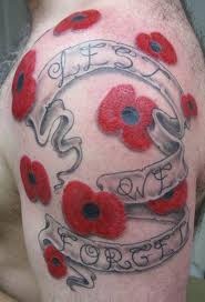 Lest we forget and red poppy tattoo on arm