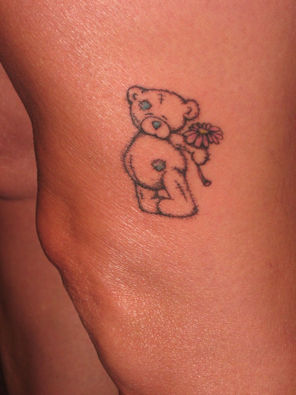 Lovely black bear tattoo on leg and pink flower