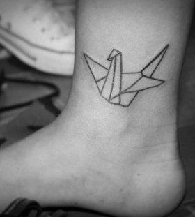 Lovely black origami tattoo on leg