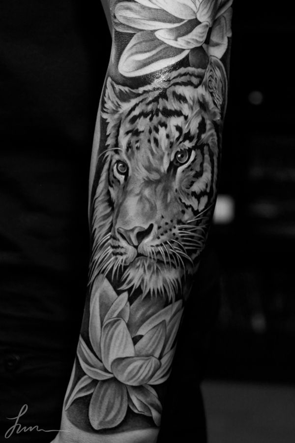 Lovely flowers and tiger tattoo on arm