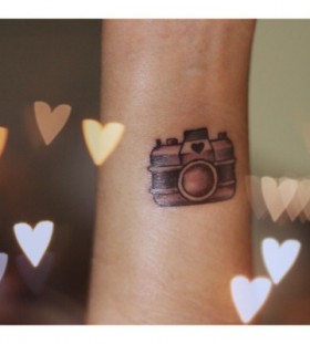 Lovely heart and camera tattoo on arm