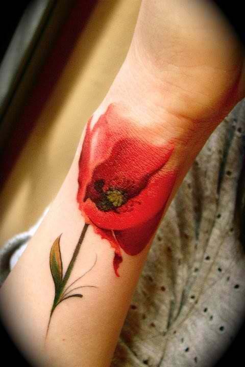 Lovely poppy flower tattoo on hand